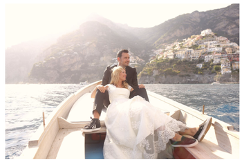 Picture of a bride and groom on a boat. 