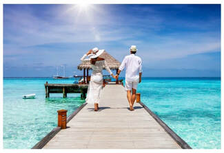 Picture of couple walking on a beach pier.