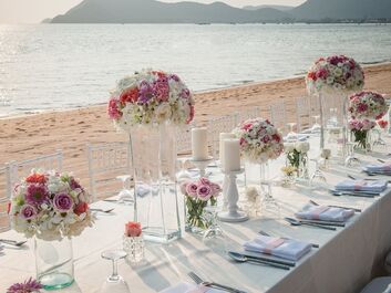 Picture of a table set for a wedding by the beach.